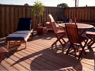 Contractors securing decking tiles during a Trex decking installation in a Glendale backyard.